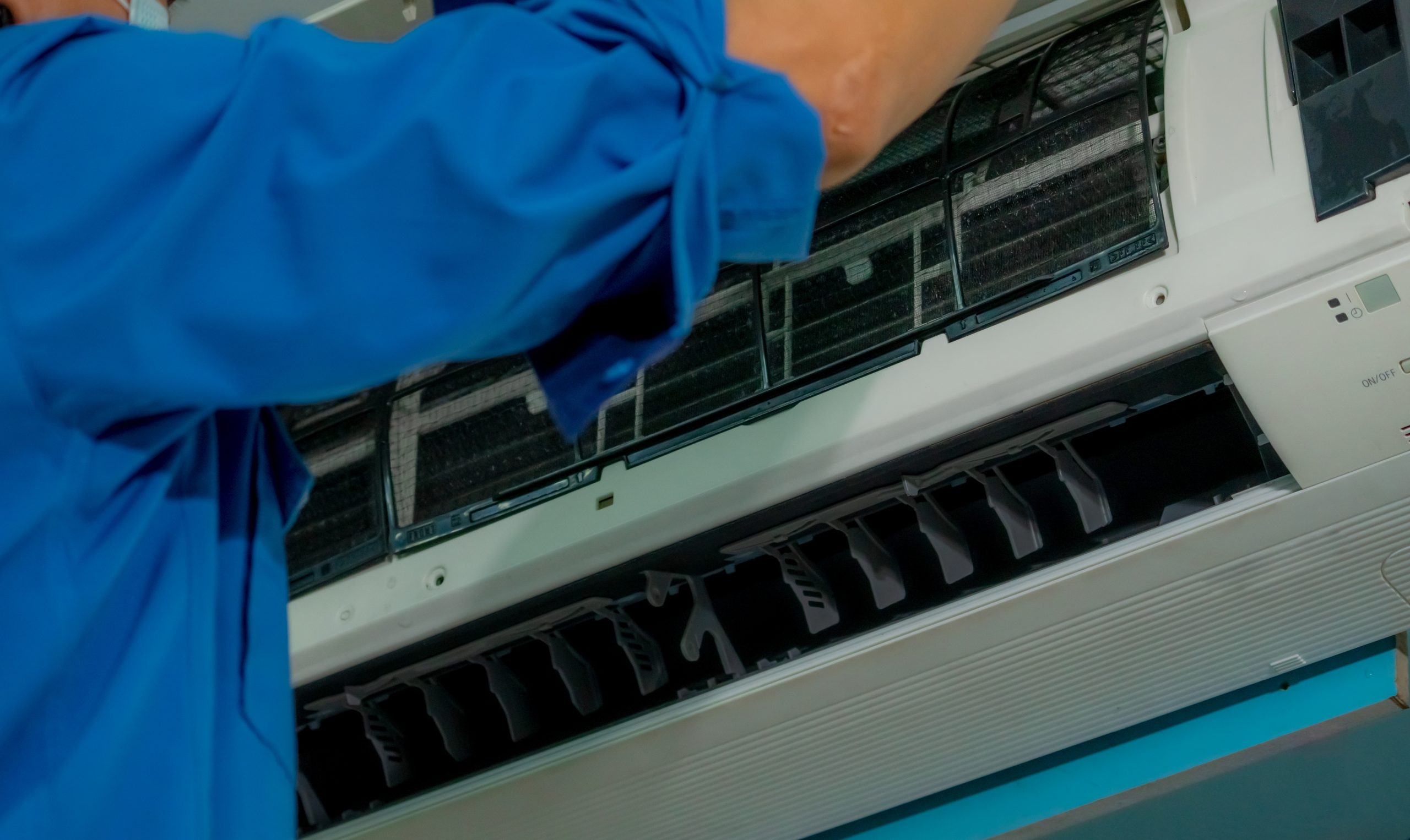 air conditioner repair by man technician clean air conditioner that installs wall ac scaled