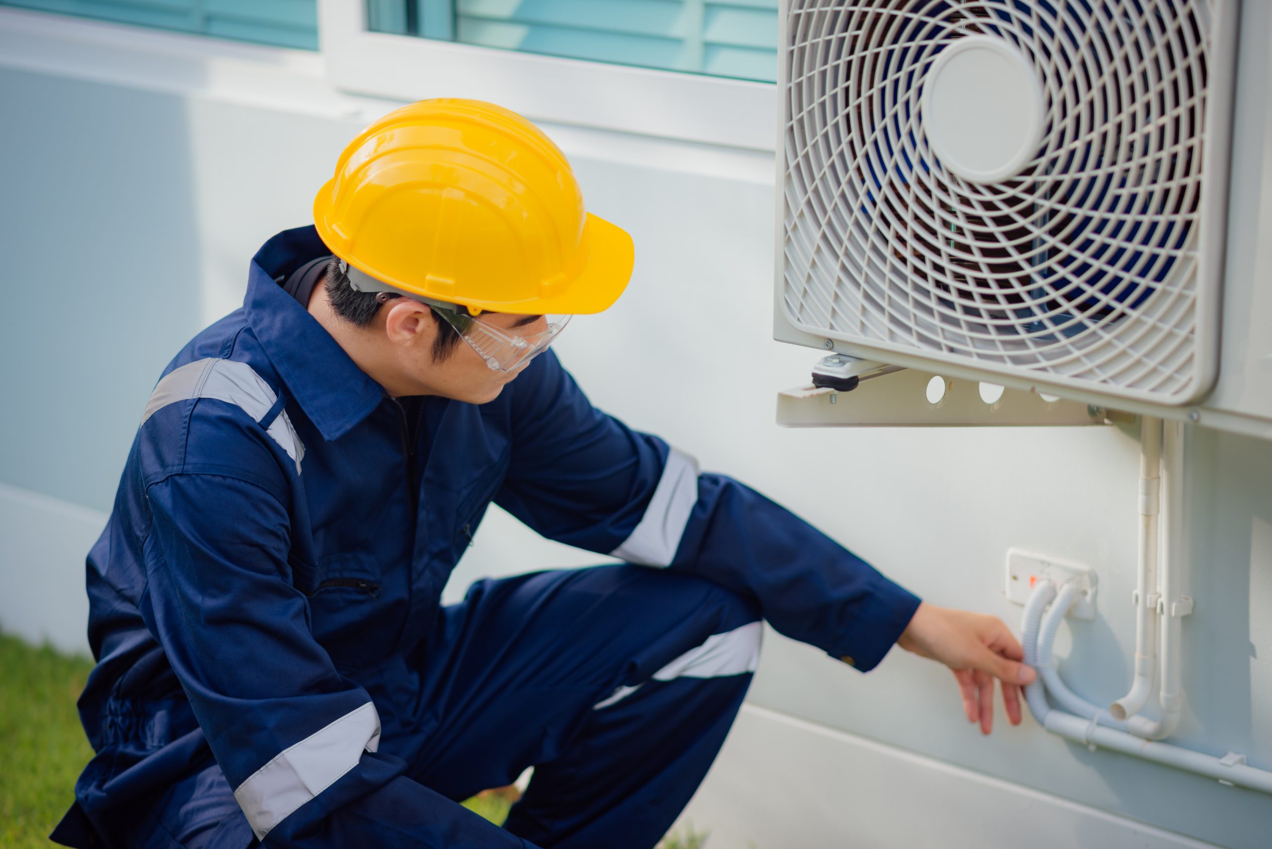 male technician checking cooling pipeline air conditioner outdoors scaled